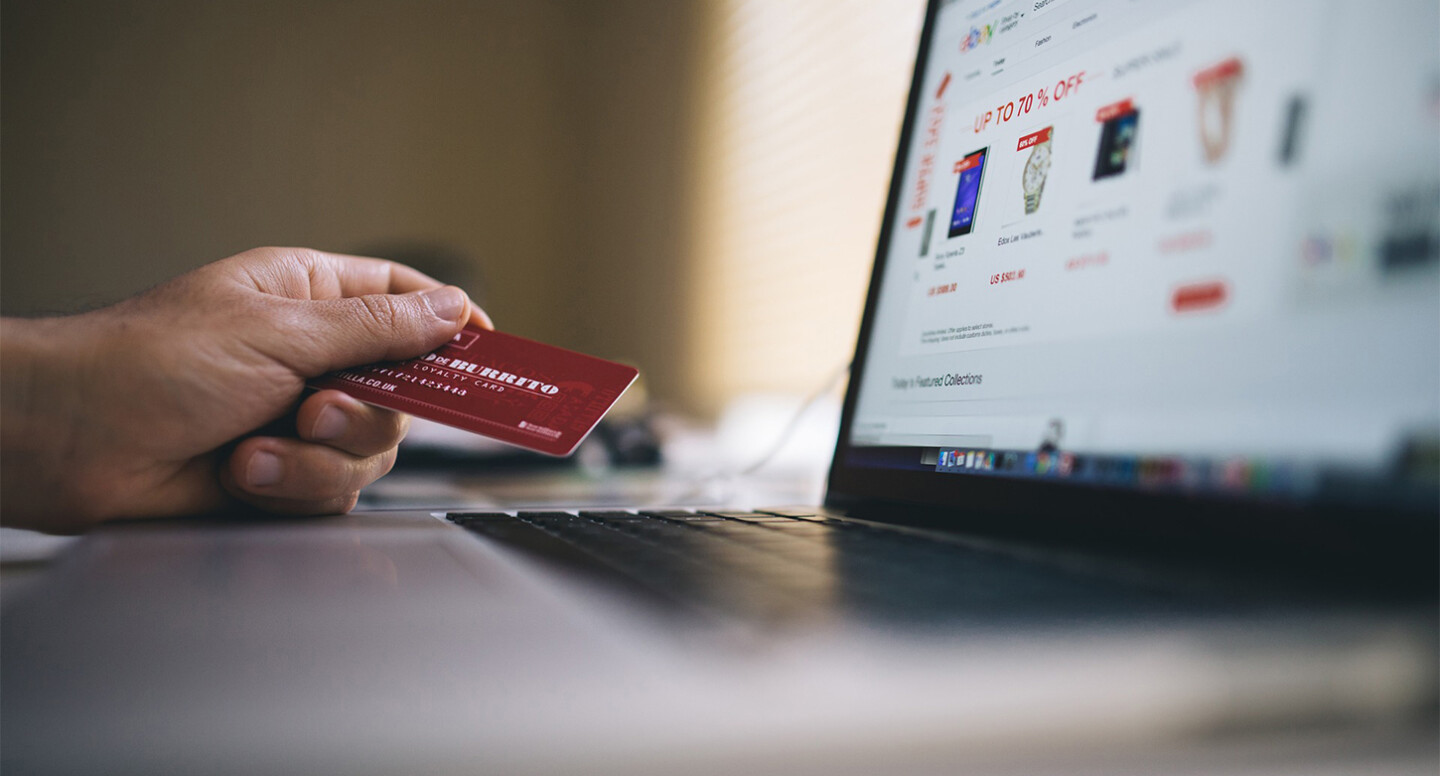 Holding the credit card in hand for making a purchase on an e-commerce website